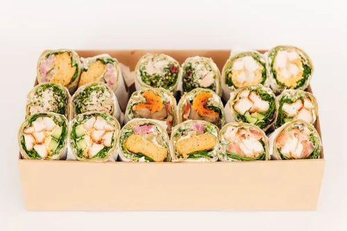 Assorted Wraps by Top Fruit Market, 36-piece selection of fresh fruit and savory wraps on a wooden platter.