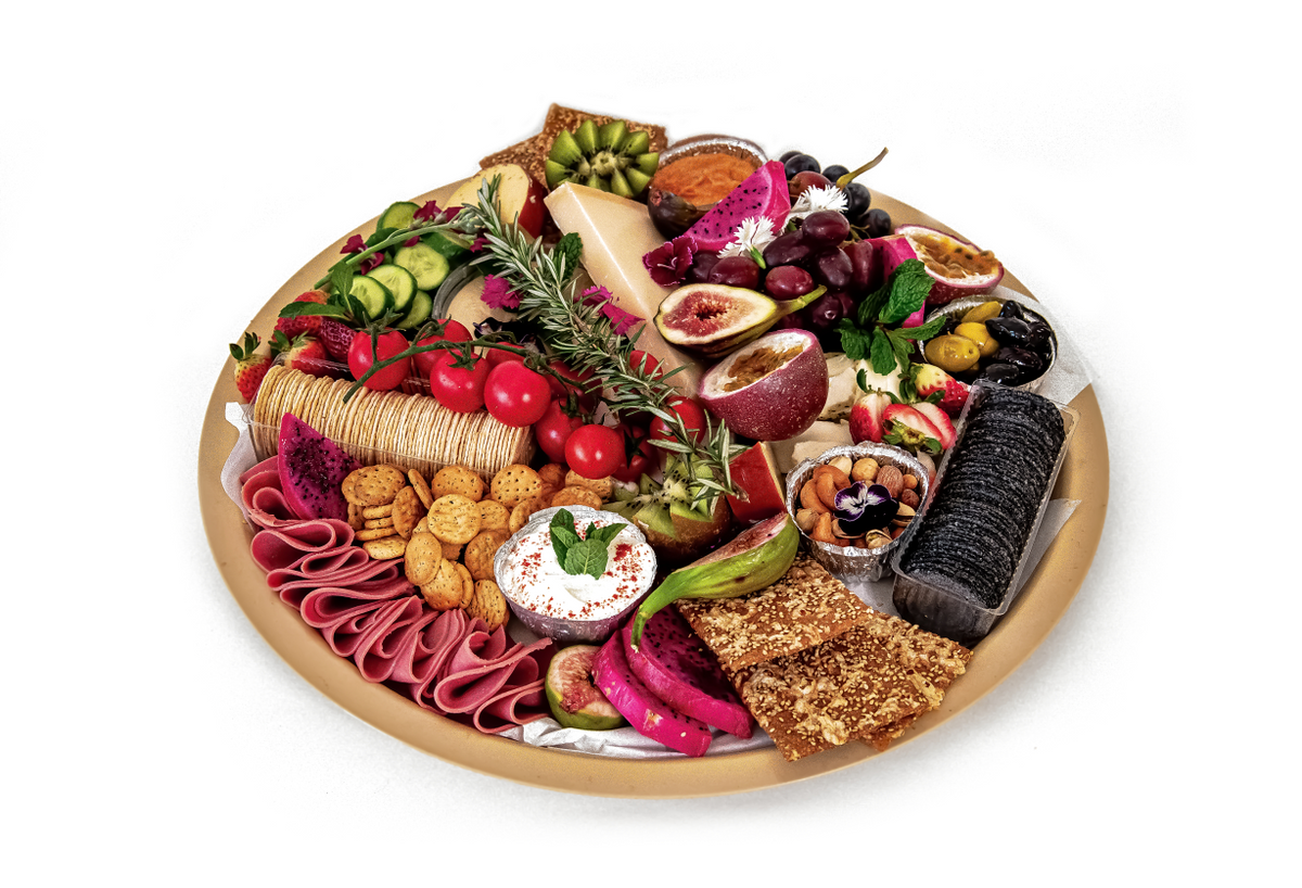 Top Fruit Market grazing platter with assorted cheeses, fruits, and nuts arranged on a wooden board for sharing.