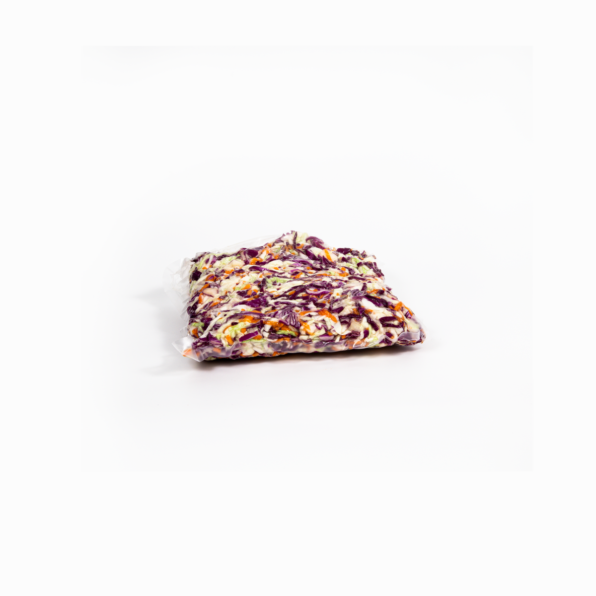 Fresh coleslaw in a fridge container, featuring shredded cabbage and carrots, from Top Fruit Market.
